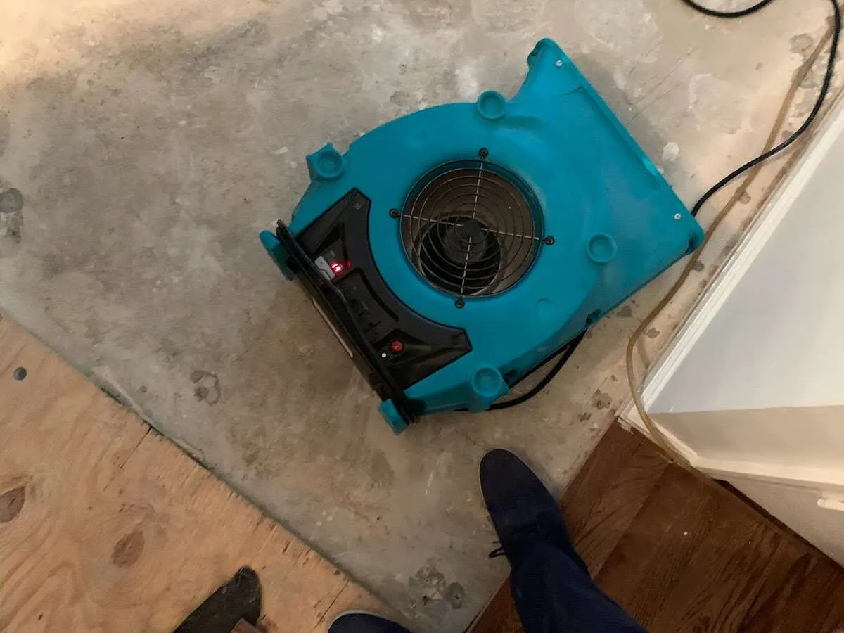 Air mover drying subfloor during Commercial Water Damage Restoration in Estero